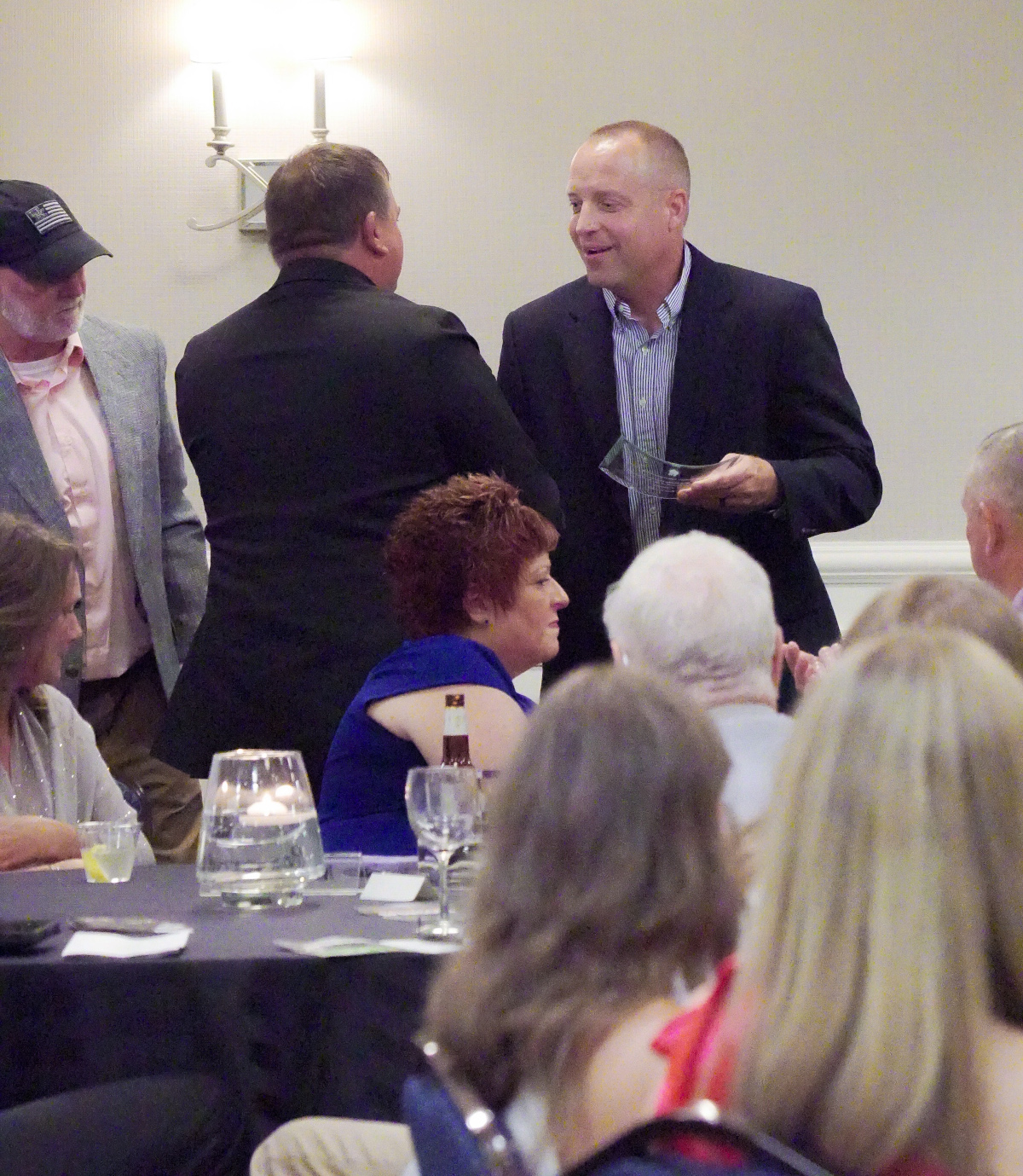 New Belfry High School head football coach and long time assistant under Coach Haywood, Matt Varney, accepts the honor on behalf of the Coachâs family and staff.